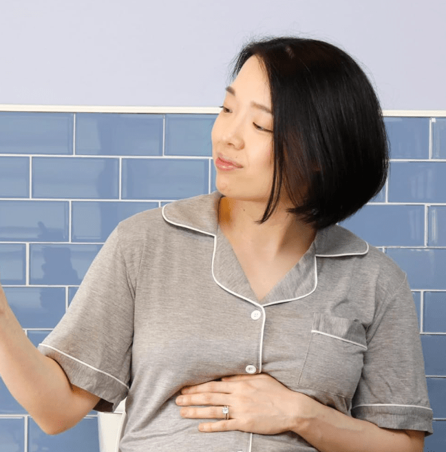A woman holding a portable bidet.